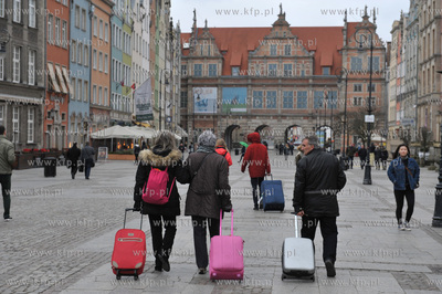 Gdansk. Turysci poza sezonem, przemierzaja z walizami...