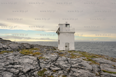 Irlandia. Latarnia morska osadzona na surowych skalach...