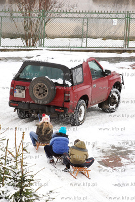 Zima w Rumi. Nz. Kulig za samochodem na ul. Kieleckiej

Fot....